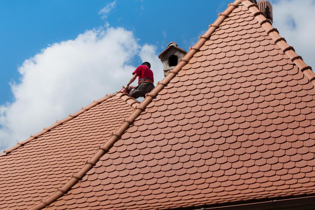 Our roofers repairing the roof